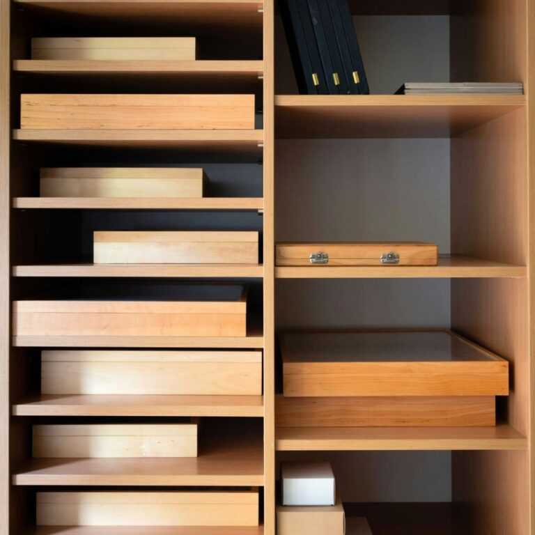 a wooden set of drawers with organized papers in them