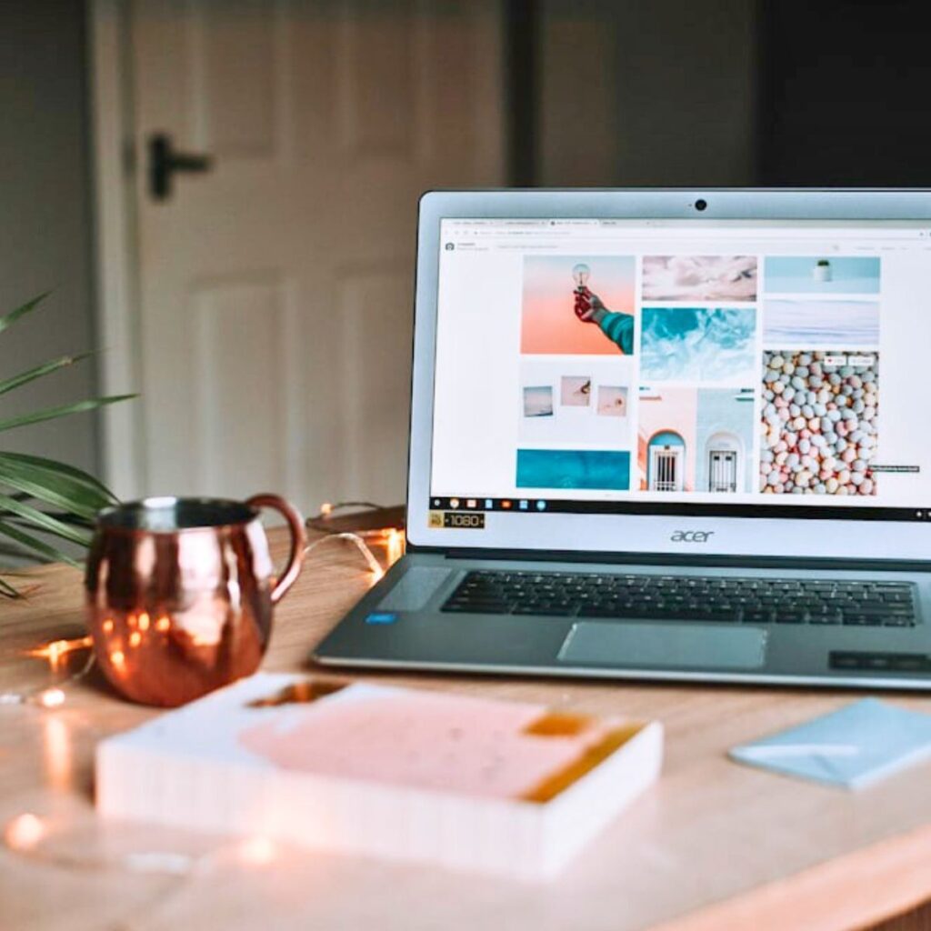 a laptop with digital clutter and a book on a desk to save storage space